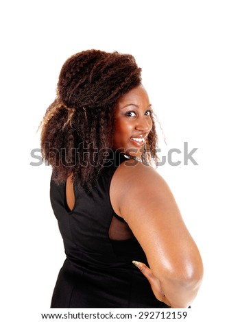 A portrait picture of a African American woman in a black dress with her
hands on her hips, isolated for white background.
