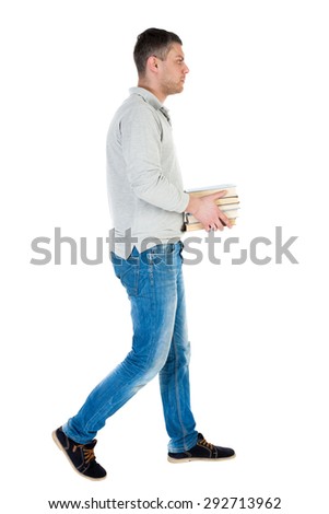 Back view of going  handsome man carries a stack of books. walking young guy . Rear view people collection.   Isolated over white background. A guy in a gray thoughtfully comes with a stack of books