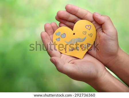 Child's hands with a Father's Day card