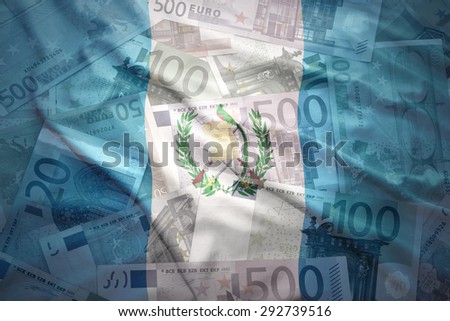 colorful waving guatemalan flag on a euro money background