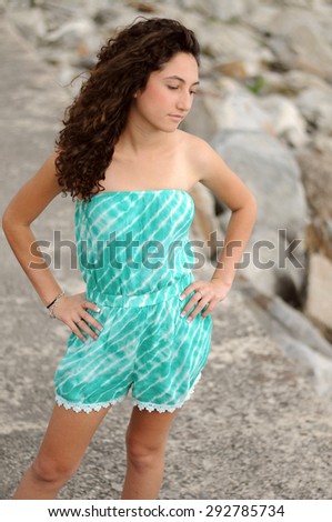 Teenage girl standing alone at beach