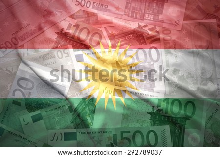 colorful waving kurdish flag on a euro money background