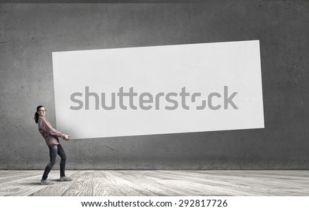 Young girl carrying white blank banner place for text