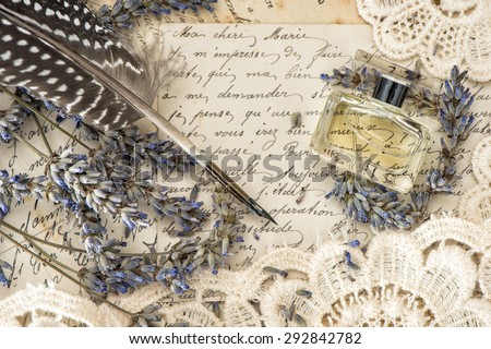 vintage ink pen, perfume, lavender flowers and old love letters. retro style toned picture