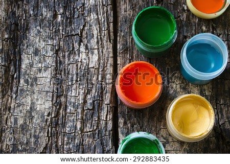 colorful gouache paint on an old wooden table