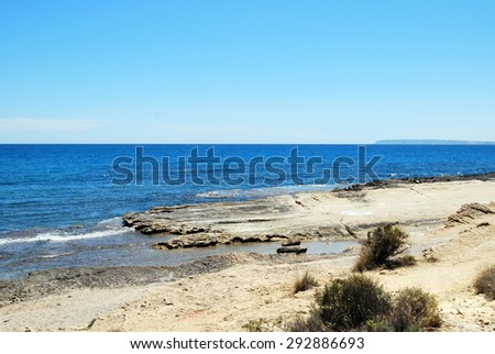 Beautiful blue sea with shore and clear sky.
