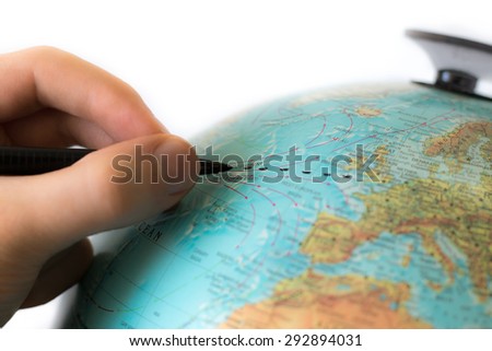 Human hands draws a line across the Atlantic, possibly planning a transatlantic journey from the UK to the USA. Royalty-Free Stock Photo #292894031