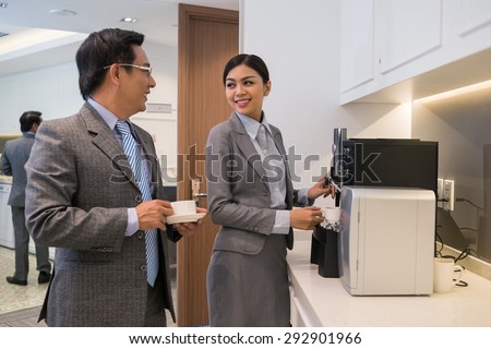 Business colleague having coffee break in the office Royalty-Free Stock Photo #292901966