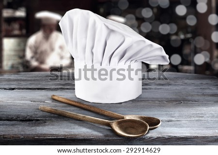 white cook hat and two wooden spoons 