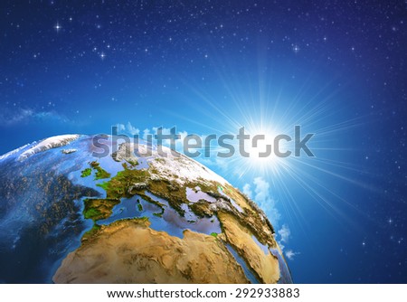Rising sun over the Earth and its landforms, view of Europe, North Africa and Middle East. Elements of this image furnished by NASA