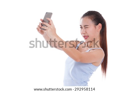 Happy asian woman taking a selfie using her smartphone 