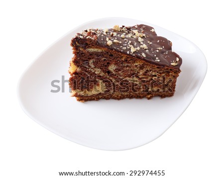 A piece of glazed sprinkled with nuts cake on white dish isolated on white background. Side view.