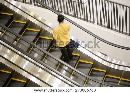  maid clean escalator, Wet floor caution sign on hotel corridor floor.