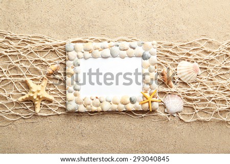 Frame of sea shells on beach sand