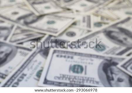 Mount of hundred dollar banknotes background texture defocused