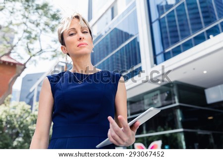 Businesswoman in city holding his notebook