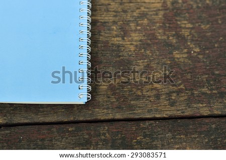 blue notepad on old wood background
