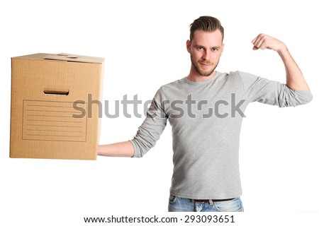 An attractive man lifting a carboard box and flexing his muscle, wearing a grey shirt with jeans. White background.