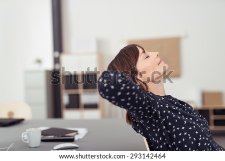 Tired Office Woman at her Worktable, Leaning her Back on a Chair with Hands at the Back of her Head and Eyes Closed, Emphasizing of Thinking Something. Royalty-Free Stock Photo #293142464