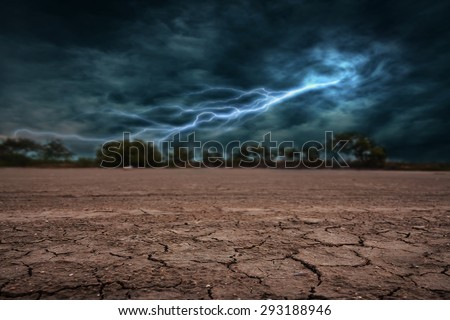 Land to the ground dry and cracked. With lightning storm Royalty-Free Stock Photo #293188946