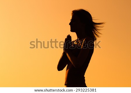 Silhouette of a woman meditating.Peace of mind Royalty-Free Stock Photo #293225381