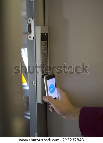 nfc's mobile phone use for open safety door Royalty-Free Stock Photo #293237843