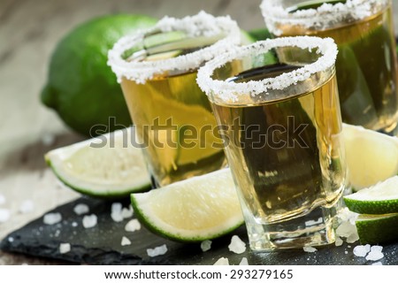 Gold Mexican tequila with lime and salt, selective focus Royalty-Free Stock Photo #293279165