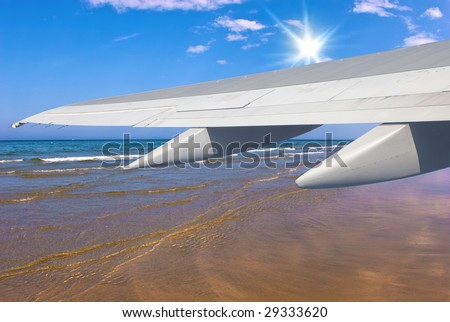 Plane's Wing Over A Summer Sea and Sky