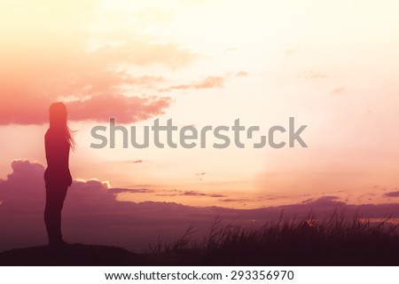 woman standing alone at the field during beautiful sunset Royalty-Free Stock Photo #293356970