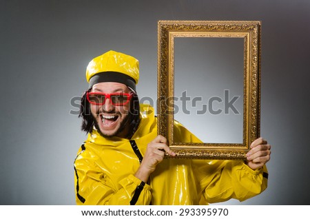 Man wearing yellow suit with picture frame