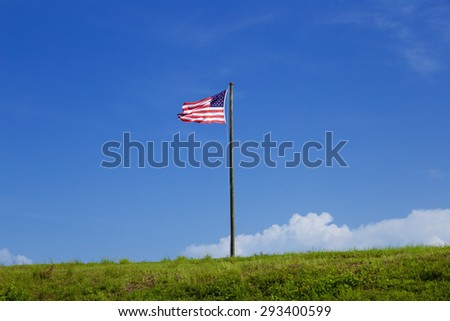 American / USA flag on a green hill