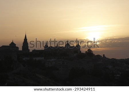 Dawn in Toledo, Castilla La Mancha,Spain, backlit, yellow background and black silhouette sky over the city silhouette view of the main medieval monuments,creative photographs of Munimara,munimara.com