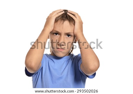 Teenage boy shouting and holding his head with hands on white background