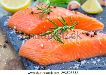 Fresh raw salmon fillet with seasonings Royalty-Free Stock Photo #293503532