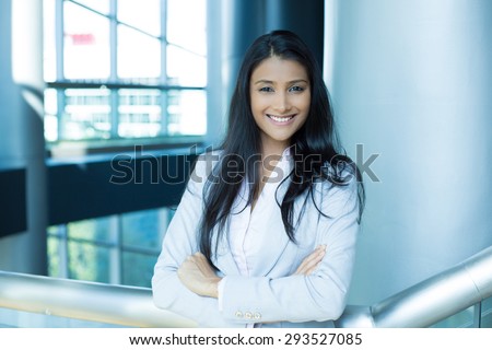 Closeup portrait, young professional, beautiful confident woman in pink shirt gray suit, arms crossed folded, smiling isolated indoors office background. Positive human emotions Royalty-Free Stock Photo #293527085