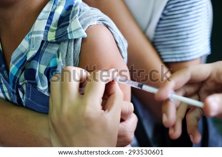 Shot of human hands making an injection with a syringe Royalty-Free Stock Photo #293530601