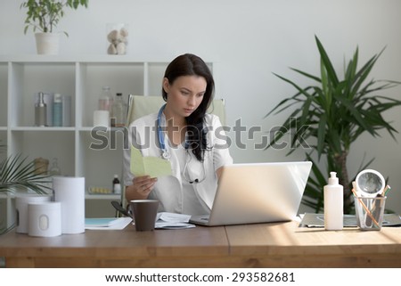 Doctor analyzing medical test results of her patient at her office