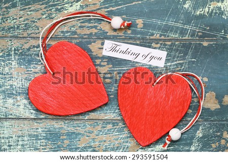 Thinking of you card with two red wooden hearts
