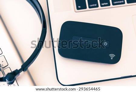 Mobile Hotspot Wi-Fi Device and Laptop Workstation. Cellular Broadband Technology. Internet On The Go. Royalty-Free Stock Photo #293654465