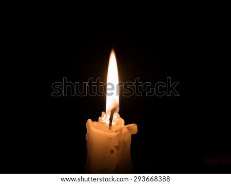 Orange Candle light on black background with space of copy