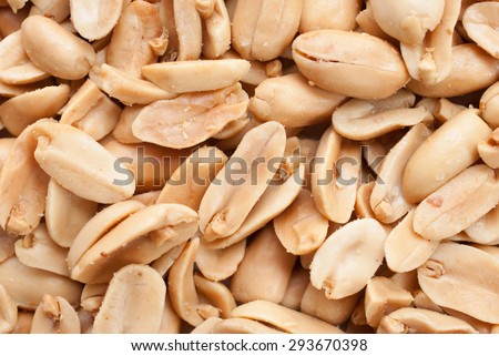 Peanuts. Close up of fried, peeled and salted peanuts on white background