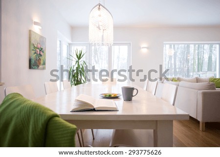 Book on the table in cozy living room interior