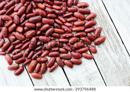 Close up red kidney bean seed sac on grunge white table. Nutrition concept.