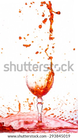 Glass of red fresh water, Water flows into the glass make splash isolated on a white background, water drop splash on white background