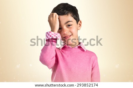 Child combing over ocher background