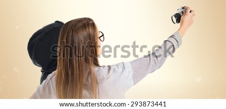 Sisters making a selfie over ocher background