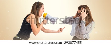 Girl shouting at her sister by megaphone  