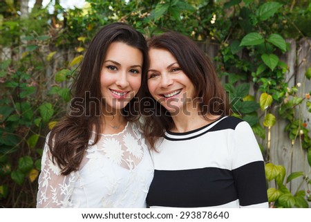 Mother and daughter portrait in a outdoor setting. Royalty-Free Stock Photo #293878640