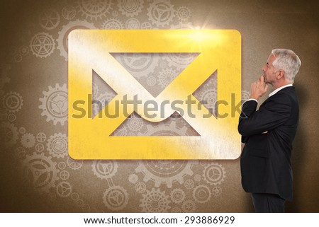 Thoughtful mature businessman posing against grey