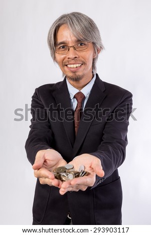 Asian Business man with Japan Coins in hands (yen)